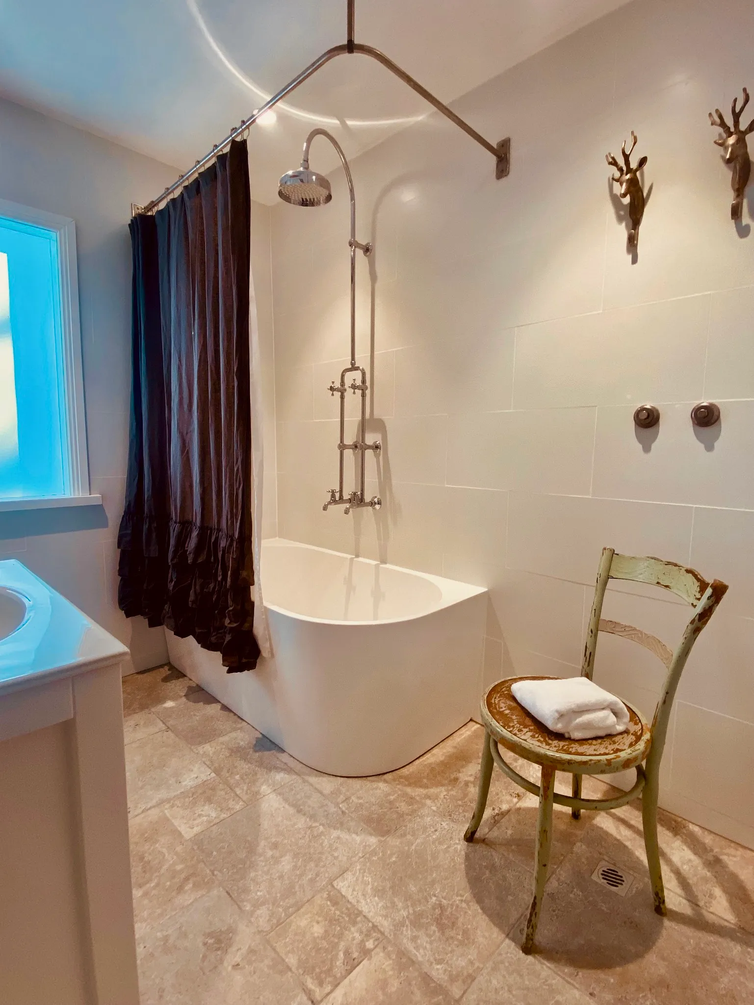 Renovated bathroom with deep bathtub and walk-in shower