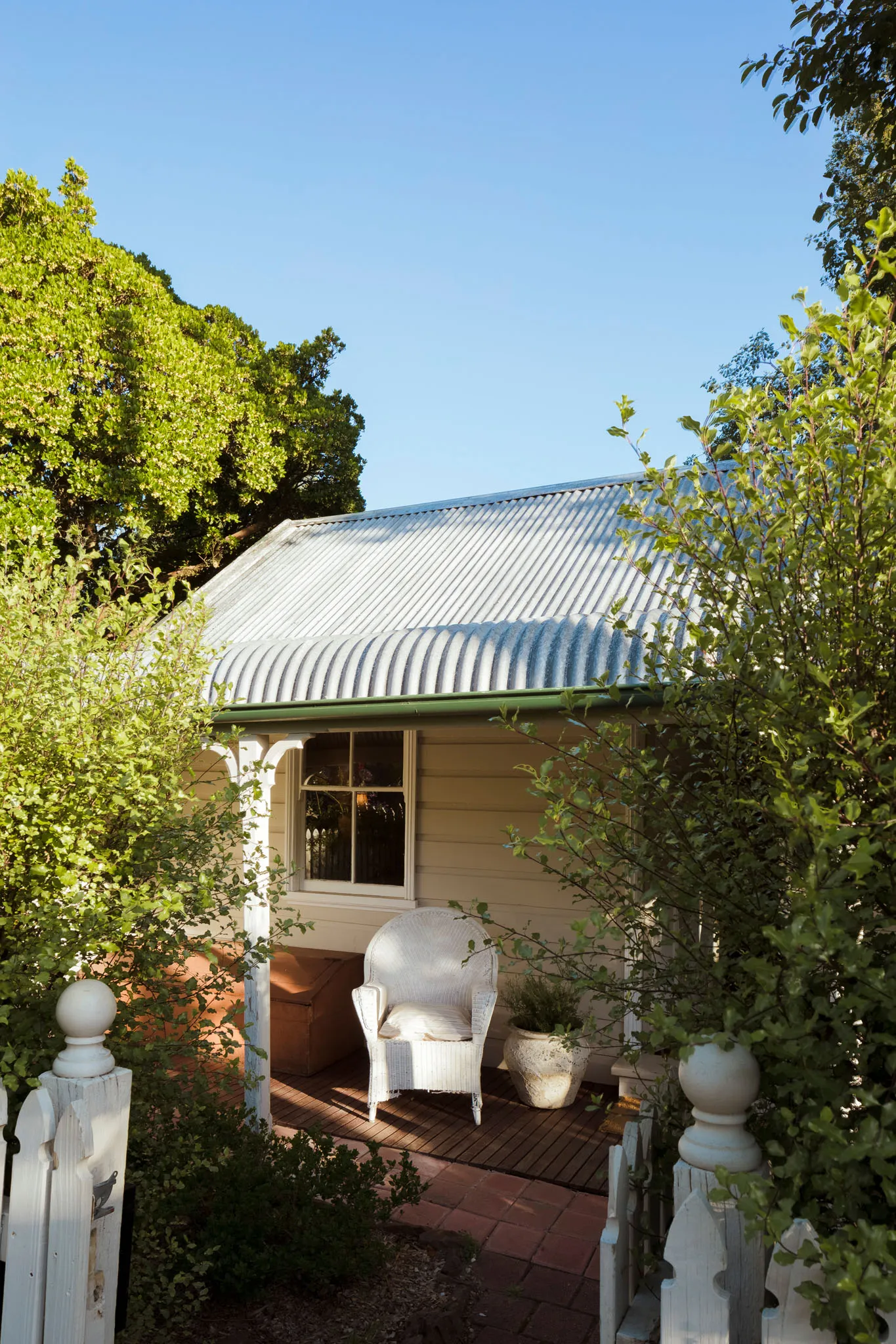 Corrugated tin roofline and verandah chair in afternoon light
